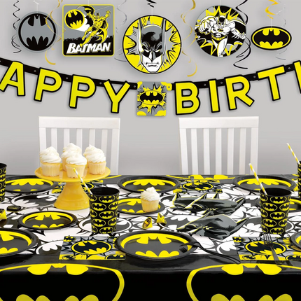 Batman-themed birthday party setup with tableware, decorations, and 'Happy Birthday' banner.