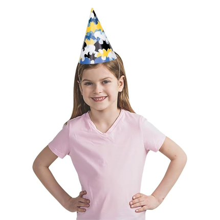 Child wearing a batman paper hat on a white background