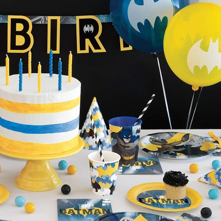 Batman-themed birthday party setup with cake, balloons, and decorations.