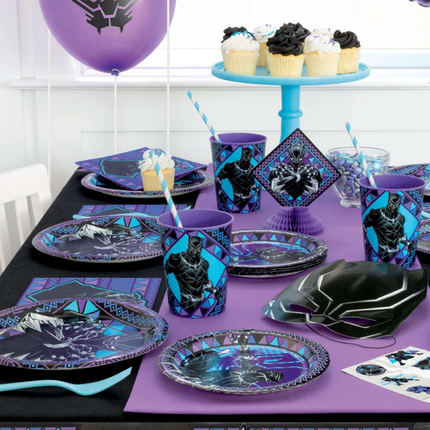Table setting with Black Panther-themed plates, cups, and decorations on a purple tablecloth.
