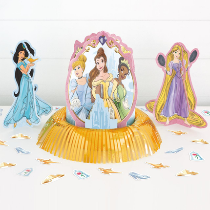 Disney princess party decoration set featuring a central pop-up stand with Belle, flanked by Jasmine and Rapunzel cutout figures, with scattered shoe-shaped confetti on a white surface.