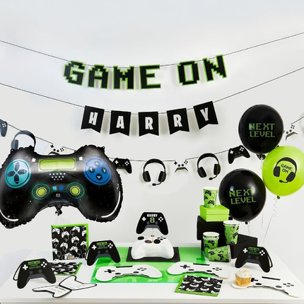 Gaming-themed party setup with controllers, balloons, and 'Game On' banner.