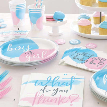 Gender reveal party supplies including plates, cups, and napkins on a table.