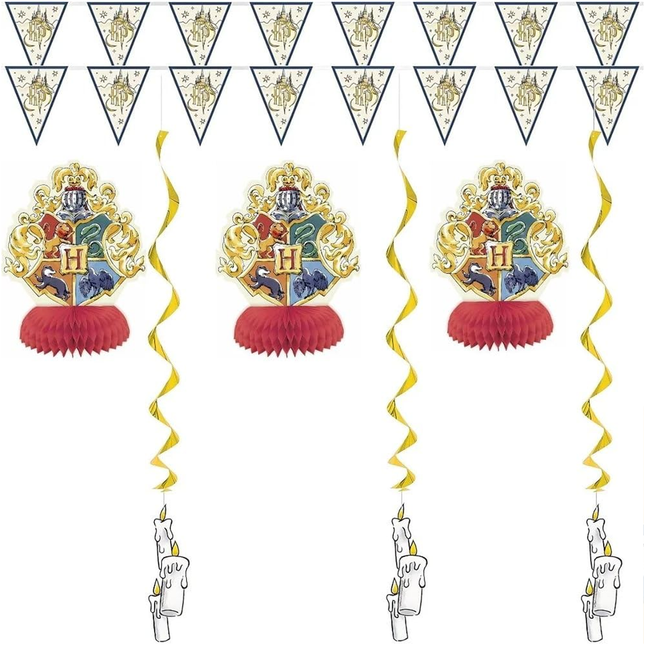 Decorations with Hogwarts crest, candles, and banner on a white background