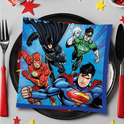 Superhero-themed napkin on a plate with cutlery and decorative stars.