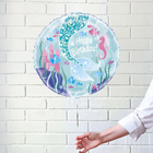Round birthday balloon with undersea design and 'Happy Birthday!' text on a white brick wall background.