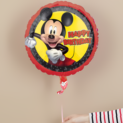 Mickey Mouse birthday balloon with 'Happy Birthday' text on a beige background