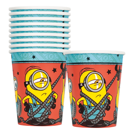 A stack of and individual paper party cups featuring a cartoon Minion design on a red background with a blue patterned band at the top, shown on a white background.