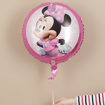Minnie Mouse balloon held by a person against a beige background