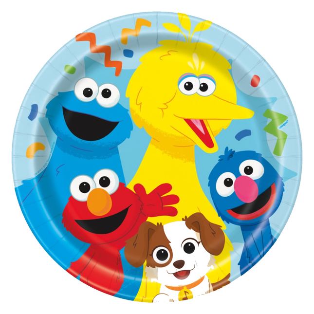 A round paper party plate featuring colorful Sesame Street characters including Big Bird, Cookie Monster, Elmo, Grover, and a small brown-and-white dog on a light blue background with confetti.