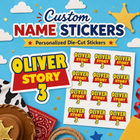 Toy Story Themed Custom name stickers featuring a western theme, shown on a white sheet with multiple red and yellow 'Oliver Story' name stickers. The background is a bright blue sky with clouds, stars, and a gold sheriff's star badge, with themed props like a cowboy hat, bandana, rope, and gift box at the bottom.