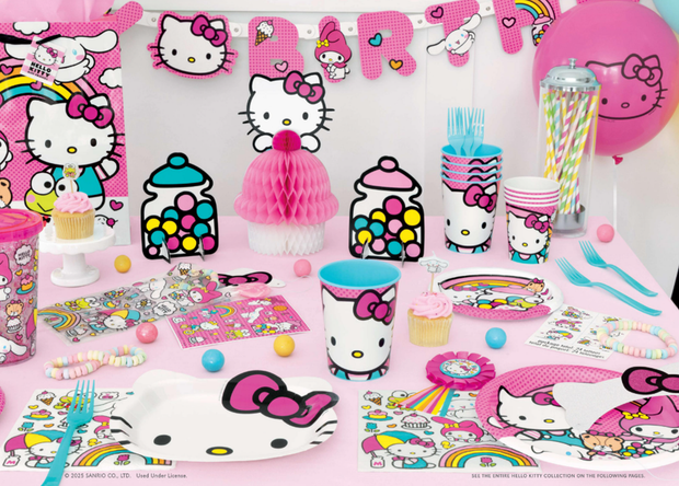 Hello Kitty-themed party supplies including cups, plates, and decorations on a pink tablecloth.